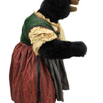 Stuffed bear in a vintage outfit with a green hood and red dress on a white background
