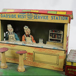 Toy service station with characters and 'Roadside Rest Service Station' branding on a white background