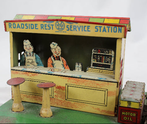 Toy service station with characters and 'Roadside Rest Service Station' branding on a white background