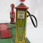 Vintage toy gas pump with 'Gas' sign on a white background