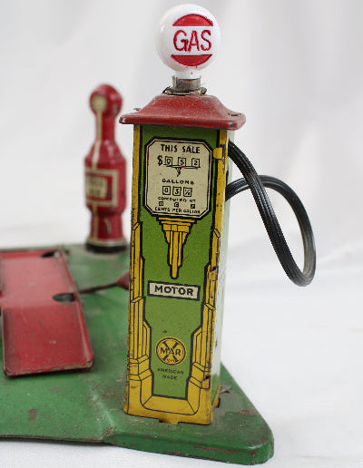 Vintage toy gas pump with 'Gas' sign on a white background