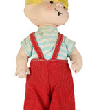 Toy figure with blonde hair, striped shirt, and red overalls on a white background