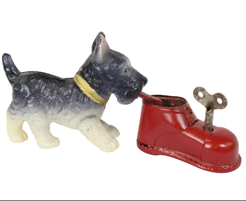 Toy dog with a red boot on a white background