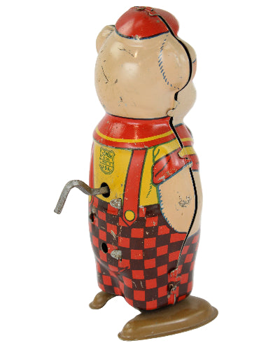 Vintage tin toy with checkered pattern on a white background