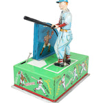 Vintage toy figure of a baseball player with a green box featuring baseball-themed illustrations on a white background.