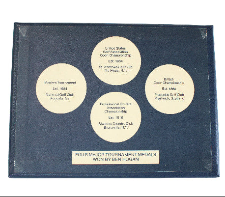 Medal display case with four major tournament medals won by Ben Hogan on a white background