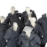 Set of mannequins dressed in dark coats and hats on a white background