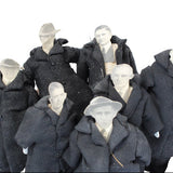 Set of mannequins dressed in dark coats and hats on a white background