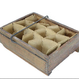Wooden box with compartments containing triangular brown objects on a white background