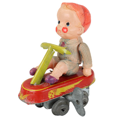 Vintage toy figure of a character with a red hat and yellow outfit on a white background