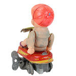 Small figurine with a red hat and backpack on a white background