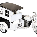 Model of a See's Candies delivery truck with a motorcycle on a black background