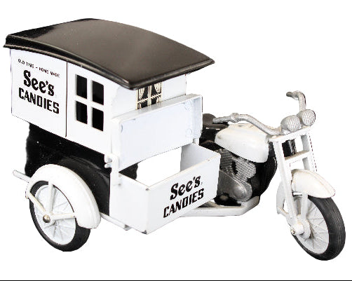 Model of a See's Candies delivery truck with a motorcycle on a black background