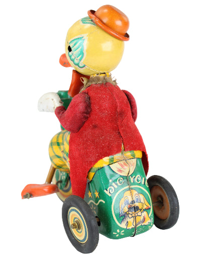 Vintage toy with a red figure and colorful wheels on a white background