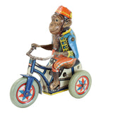 Toy monkey on a tricycle with colorful design on a white background