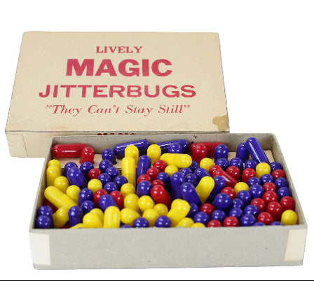 Box of colorful 'Magic Jitterbugs' toys with a vintage design.