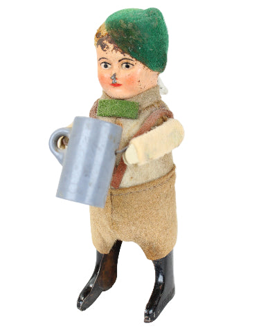 Vintage-style toy figure with a green hat and brown outfit on a white background