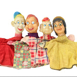 Set of vintage hand puppets with colorful clothing on a white background