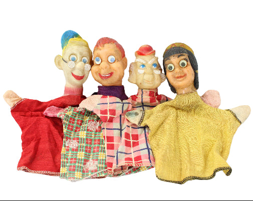 Set of vintage hand puppets with colorful clothing on a white background