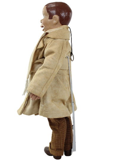 Mannequin wearing a beige outfit with brown pants on a white background