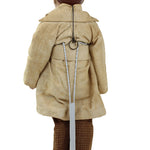 Mannequin wearing a beige coat with a brown helmet on a white background