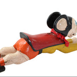 Vintage-style toy figure of a character in a top hat and red outfit on a white background