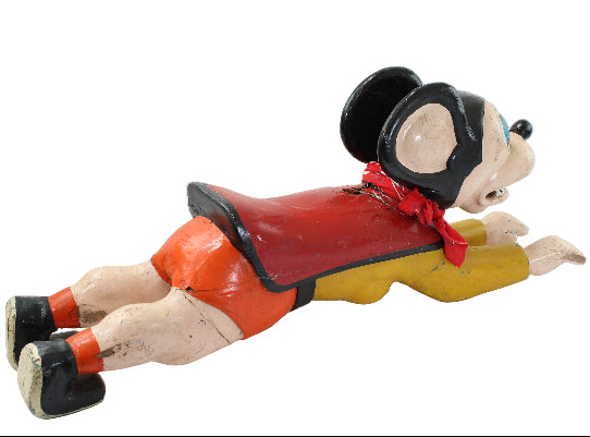 Vintage-style toy figure of a character in a top hat and red outfit on a white background