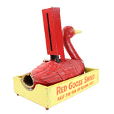 Red goose-shaped shoe jack with yellow box on a white background
