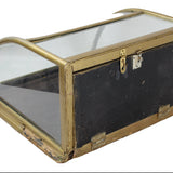 Vintage display case with glass top and brass frame on a white background
