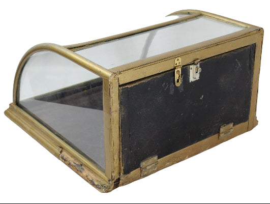 Vintage display case with glass top and brass frame on a white background
