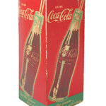 Red Coca-Cola box with green accents featuring a bottle design on a white background
