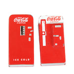 Two miniature Coca-Cola vending machines on a white background