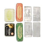 Collection of vintage tins with different designs on a white background
