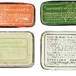 Collection of vintage small metal boxes with different designs and text on a white background