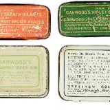 Collection of vintage small metal boxes with different designs and text on a white background