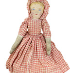 Vintage doll with a red and white checkered dress on a white background