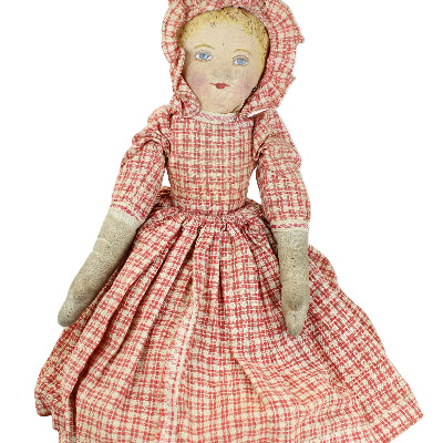 Vintage doll with a red and white checkered dress on a white background