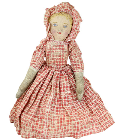 Vintage doll with a red and white checkered dress on a white background