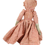 Doll wearing a red and white checkered dress on a white background