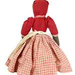 Traditional doll with a red dress and plaid skirt on a white background