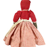Traditional doll with a red dress and plaid skirt on a white background