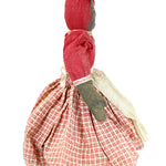 Small fabric doll with red checkered dress on a white background