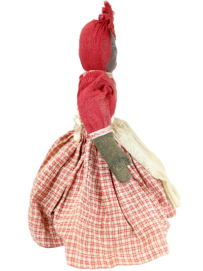 Small fabric doll with red checkered dress on a white background