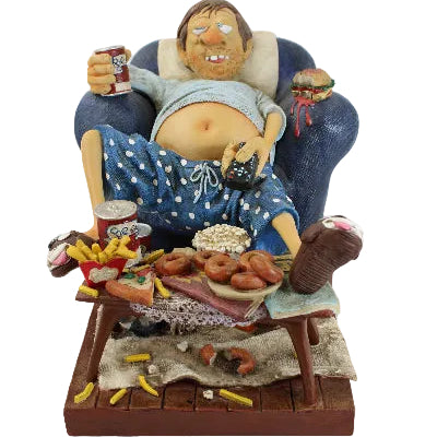 Decorative figurine of a person with a basket of food on a white background