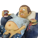 Sculpture of a person lounging in a chair with a mug and burger, on a white background