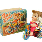 Vintage toy bike with a box labeled 'Bell Cycle' on a white background