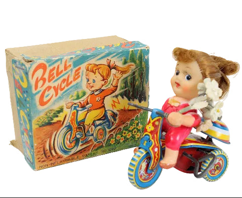 Vintage toy bike with a box labeled 'Bell Cycle' on a white background