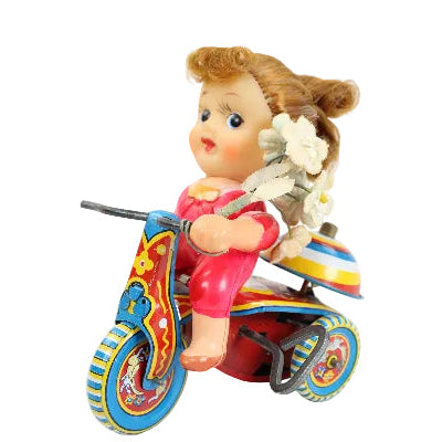 Toy figure of a girl on a motorcycle with a white background
