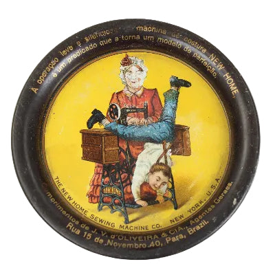 Decorative tray with vintage illustration of a woman and child on a sewing machine, on a white background.