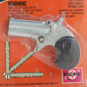 Vintage packaging of a 'Dude Geringer' premium pistol on an orange background